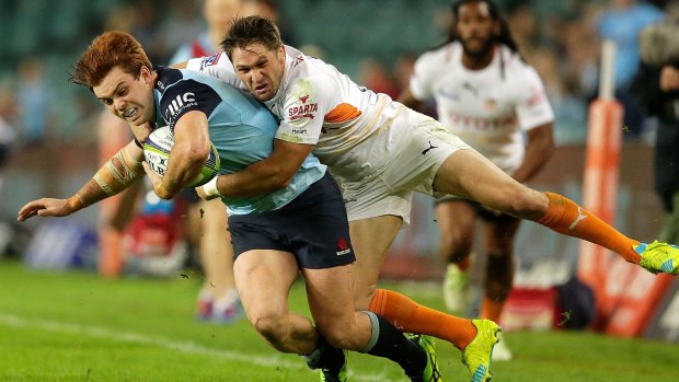 The Waratahs' Andrew Kellaway is tackled by Tian Meyer of the Cheetahs.
