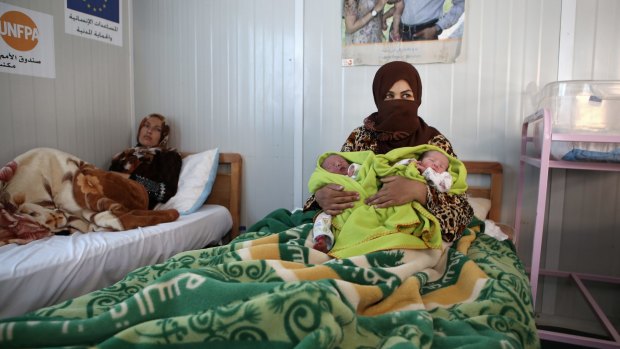 And a maternity clinic. Syrian refugee Maan Turkman, 31, holds her twin infants Mohammed, left, and Ahmed.