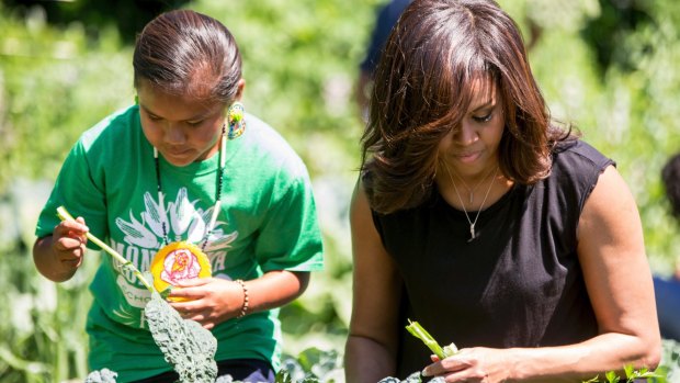 Michelle Obama, joined by school children, harvest the White House Kitchen Garden in 2016. 