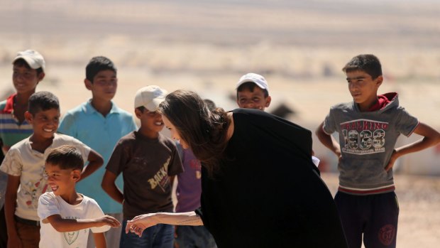 Special envoy and Goodwill Ambassador Angelina Jolie greets children during a press conference at Al- Azraq camp for Syrian refugees.