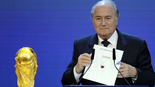 FIFA President Sepp Blatter holding up the name of Qatar during the official announcement of the 2022 World Cup host country.