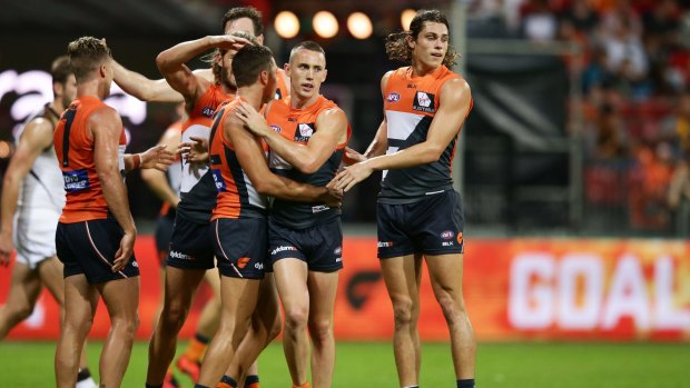 Giant strides: Tom Scully (second from right) celebrates with teammates after kicking a goal in the Giants victory over Hawthorn.