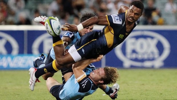 Tough battle: Henry Speight of the Brumbies gets the ball away against the Waratahs.