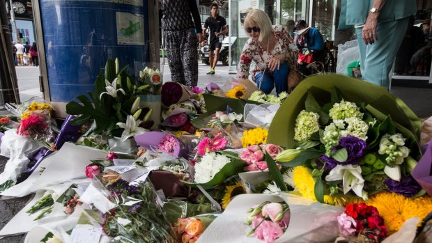 Floral tributes for Josie Edden gather at the city intersection.