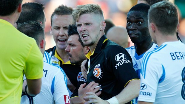 More than blue collar: Andy Keogh of the Glory remonstrates with Victory players during their eventful clash in Perth.