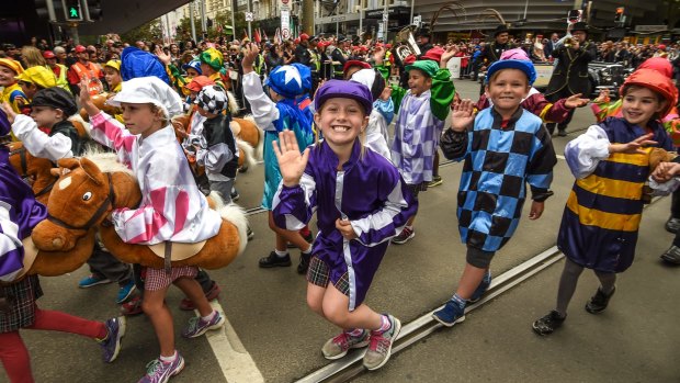 Children in jockey silks add some colour to the Melbourne Cup parade.