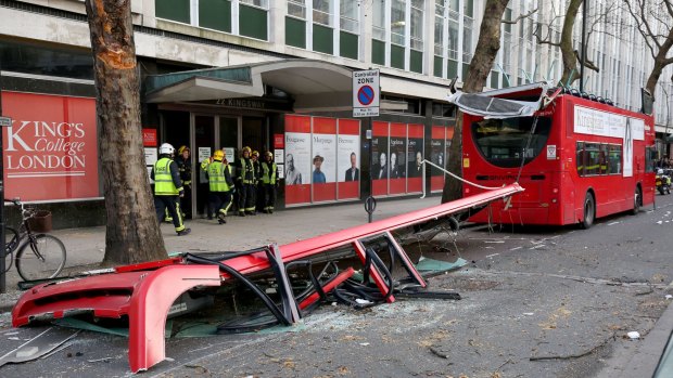 Emergency services arrive at the scene after five people were treated for minor injuries when a London bus had its roof ripped off in London.
