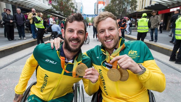 Dylan Alcott (right) with Heath Davidson during a parade to welcome home the Australian Paralympic Team in 2016.