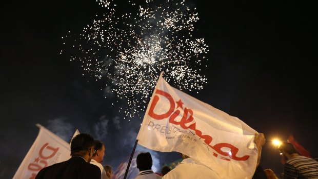 Militants of the Workers Party watch fireworks in support of Rousseff in Brasilia, during transmission of the Workers Party's TV program.