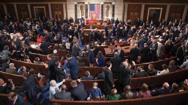 Members of the House of Representatives, some joined by family, gather as the 115th Congress gets under way in Washington on Tuesday.
