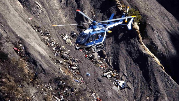 A French Gendarmerie rescue helicopter flies over the debris of the Airbus A320 at the site of the crash, near Seyne-les-Alpes.
