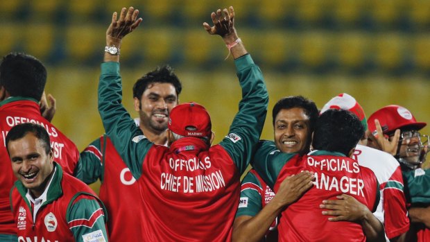 Top debut: Oman's team officials and players celebrate after beating Ireland.