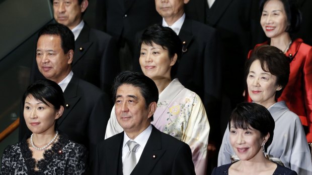 Japanese Prime Minister Shinzo Abe, with members of his cabinet, wants more women to move into management roles by 2020.