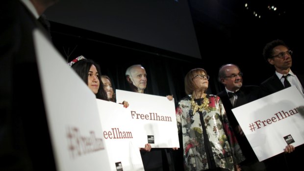 A group holds up signs in support of the jailed Chinese writer Ilham Tohti, including Salman Rushdie (second from right) at the PEN American Centre Literary Gala in New York in 2014.