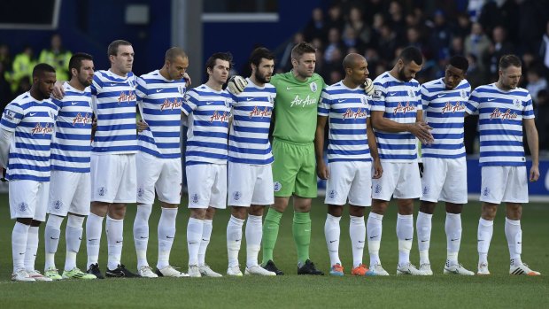 Players from Fernandes-owned QPR stand as a mark of respect.