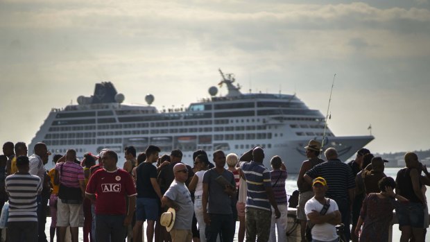 People watch Carnival's Adonia cruise ship arrive from Miami, in Havana, Cuba.