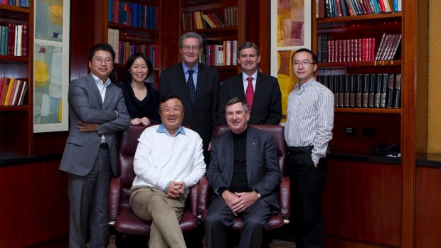 Former Huawei board member Alexander Downer (centre, back row) with Huawei executives and the regional Australian board (back row) Jeff Liu, regional president; Chen Lifang, global director; John Brumby, independent director; Guo Fulin, former Australia chief executive; (front row) Ren Zhengfei, Huawei founder and CEO; John Lord, Australian chairman.