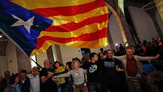 Catalan independence supporters wave a 'estelada' ( pro-independence Catalan flag ) in Barcelona.