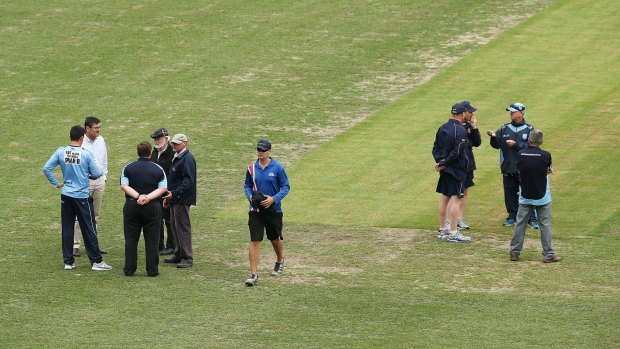 Surface tension: Match referee Steven Bernard speaks with NSW captain Moises Henriques and officials after the Sheffield Shield match between NSW and Victoria at the SCG was abandoned.