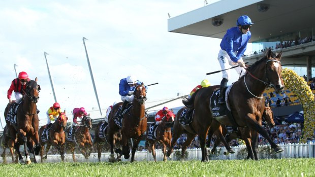 Rise for the Rose: Jockey James McDonald stands up in the irons as he crosses the line to win the Golden Rose on Astern. 