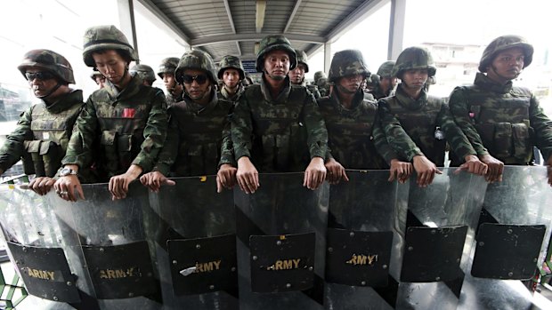 Thai soldiers guard an overpass to prevent an anti-coup demonstration in Bangkok in 2014.