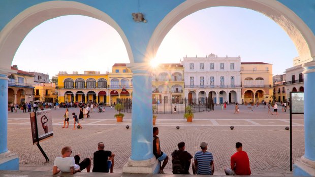 Sun setting over the colourful colonial buildings on Plaza Vieja / Old Square, Havana.