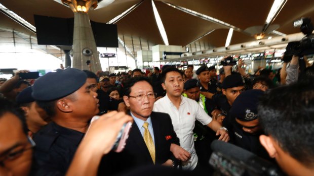 Expelled: North Korean ambassador to Malaysia Kang Chol, wearing a tie, at Kuala Lumpur International Airport in Sepang, Malaysia, on Monday.