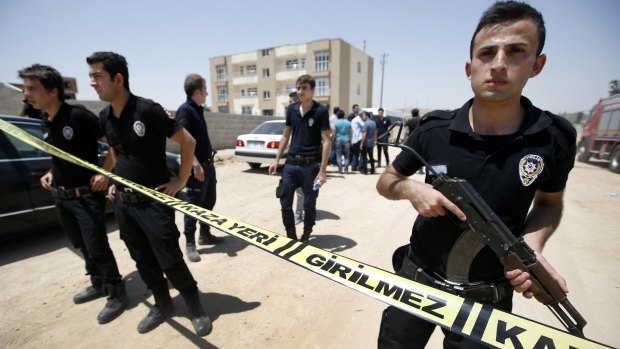 Security outside a building after two police officers were found shot dead in their home in Ceylanpinar, a town near Turkey's border with Syria, on Wednesday.