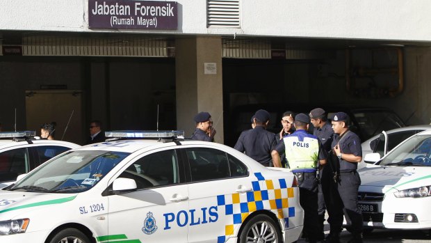 Police officers wait at the forensic department entrance at a hospital in Putrajaya, Malaysia, where Kim Jong-nam's body was taken. 