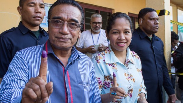 East Timorese President Francisco Lu-Olo Guterres and his wife show their fingers after voting in Dili on Saturday.