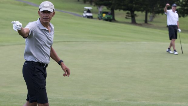 President Barack Obama celebrates after hitting a long chip shot on the 18th.