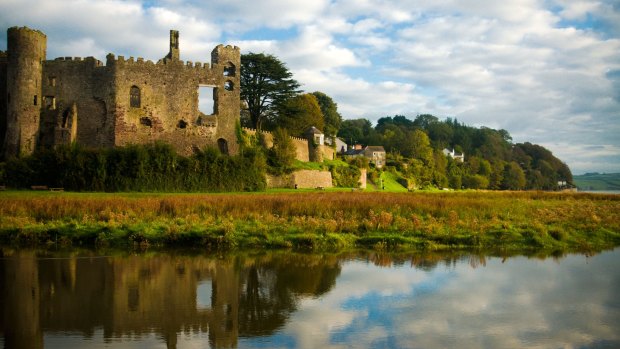 Laugharne castle in West wales with Dylan Thomas' Boathouse in the distance.