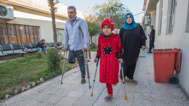 Nada and her father Adel undergo physiotherapy at the Muharabeen centre in east Mosul.