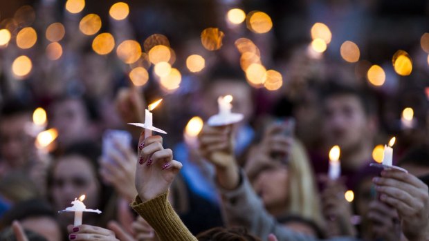 Vigil: Students hold candles aloft during at vigil on campus after the shooting of three FSU students.