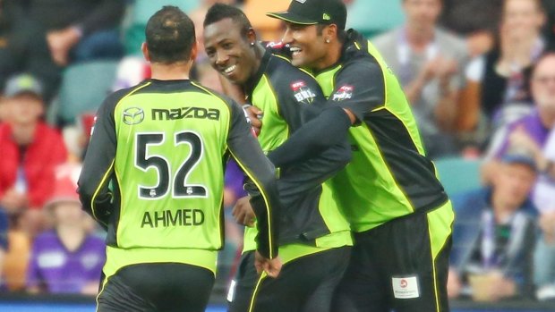Too good: Andre Russell of the Thunder celebrates with his teammates.