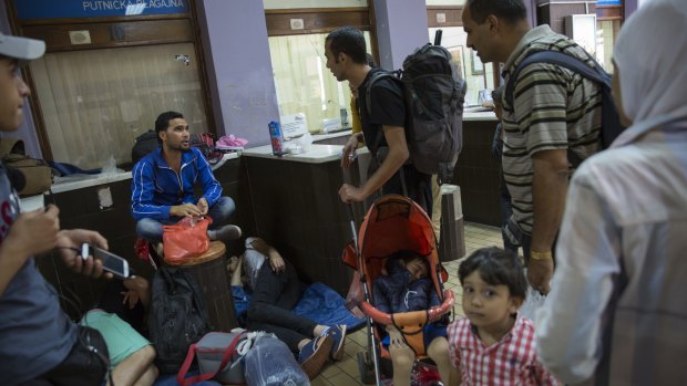 Migrant families gather in the main train station in Belgrade, Serbia. 