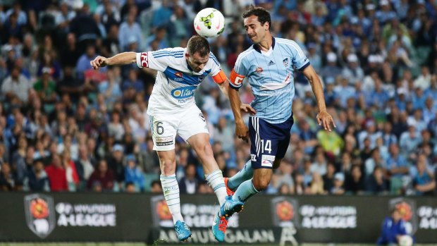 Evenly split: Alex Brosque of Sydney FC competes for the ball against Leigh Broxham of Melbourne Victory.