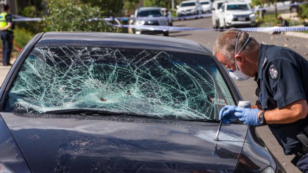 Forensic police investigate a damaged car in Attunga Grove.