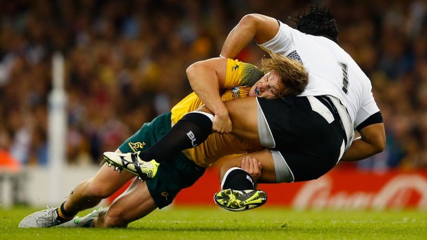 CARDIFF, WALES - SEPTEMBER 23:  Michael Hooper of Australia tackles Campese Ma'afu of Fiji during the 2015 Rugby World Cup Pool A match between Australia and Fiji at the Millennium Stadium on September 23, 2015 in Cardiff, United Kingdom.  (Photo by Laurence Griffiths/Getty Images)