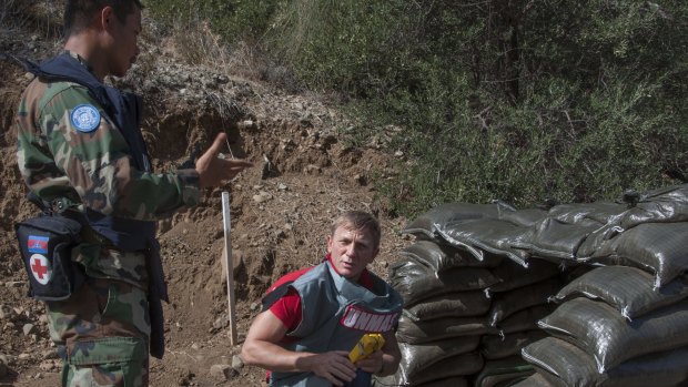 In this photo released by the United Nations Force in Cyprus on October 13, British actor Daniel Craig visits the minefields in the UN-controlled buffer zone on Cyprus, a deadly legacy of the conflict.