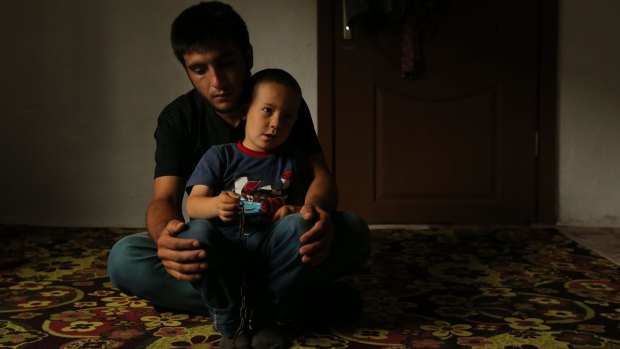 Survivor: Miner Serhat Yildirim holds his cousin Sercan, whose father died in the Soma disaster.
