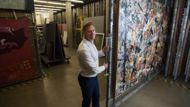 The National Gallery of Australia's assistant director of exhibitions and collections Adam Worrall with Jackson Pollock's <i>Blue Poles</i> in storage before it goes into the conservation lab.