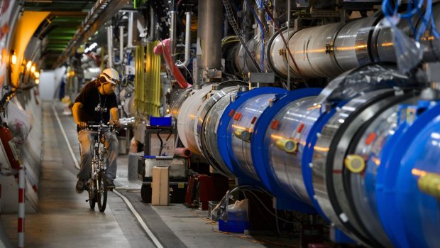 A worker rides a bicycle during maintenance checks at CERN's Large Hadron Collider.