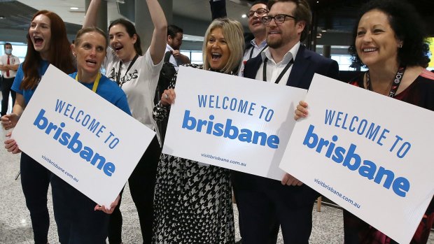 Brisbane Airport staff welcome the first passengers after borders opened in December.
