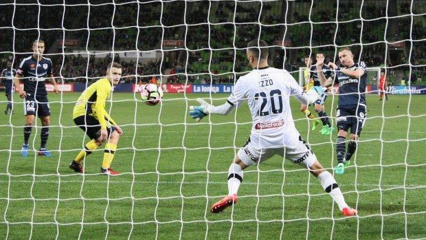 The moment: Besart Berisha of the Victory slots home his 100th goal.