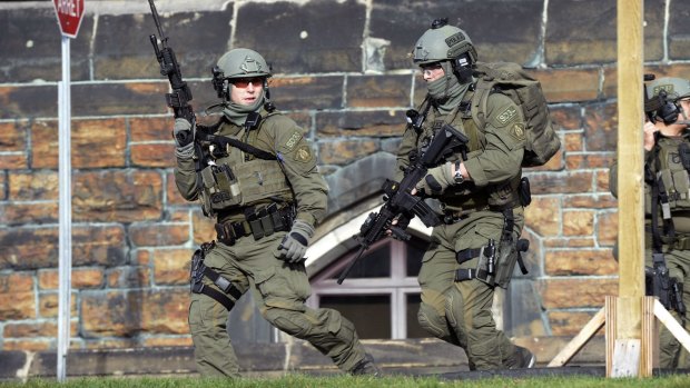 Members of a Royal Canadian Mounted Police intervention team respond to the shooting at the Parliament buildings in Ottawa.