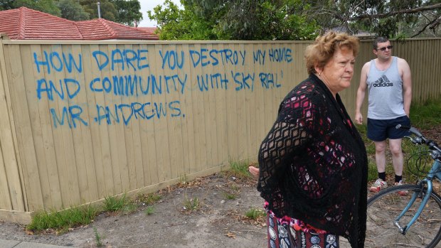 Noble Park resident Gina and son Chris Papapavlou with their angry message to Daniel Andrews. 