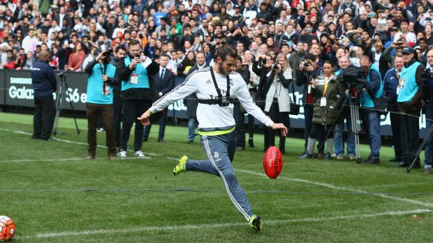 Real Madrid star Gareth Bale has a kick of a Sherrin during a training session at the MCG.