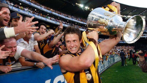 Hawthorn's Stuart Dew celebrates with the Cup after the 2008 grand final. He is now the coach of Gold Coast.