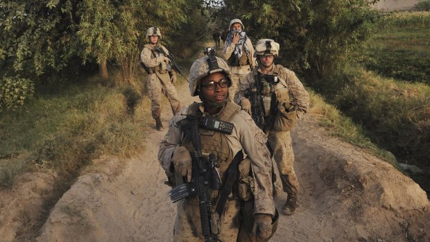 Corporal Christina Oliver, centre, and other female Marines on patrol in Afghanistan. The new Republican Party platform would bar women in the military from combat.
